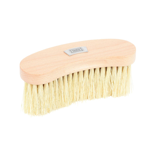 A beige-colored body brush with natural sisal bristles and a wooden handle, displaying a quality metal badge.